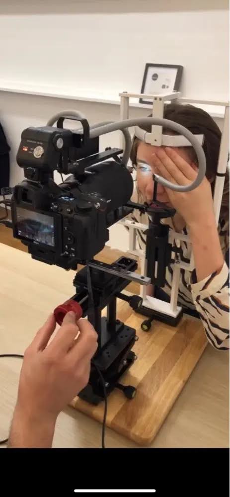 Photographer turning a red LS18 knob by hand to adjust camera position